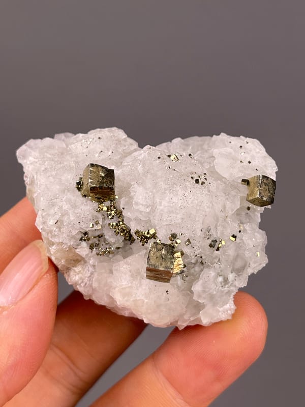 Petal-form Calcite specimen from Longyan, Fujian, China showing white matrix with sharp pyrite cubes