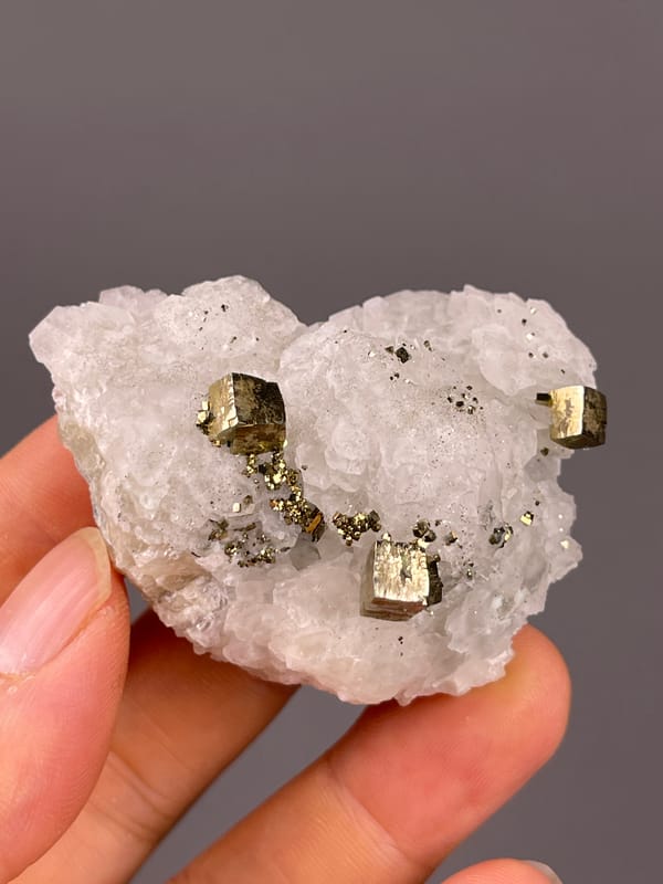 Petal-form Calcite specimen from Longyan, Fujian, China, defined by white matrix with sharp pyrite cubes