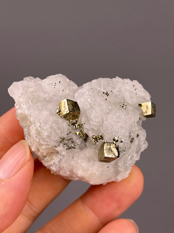 Petal-form Calcite specimen from Longyan, Fujian, China presenting white matrix with sharp pyrite cubes