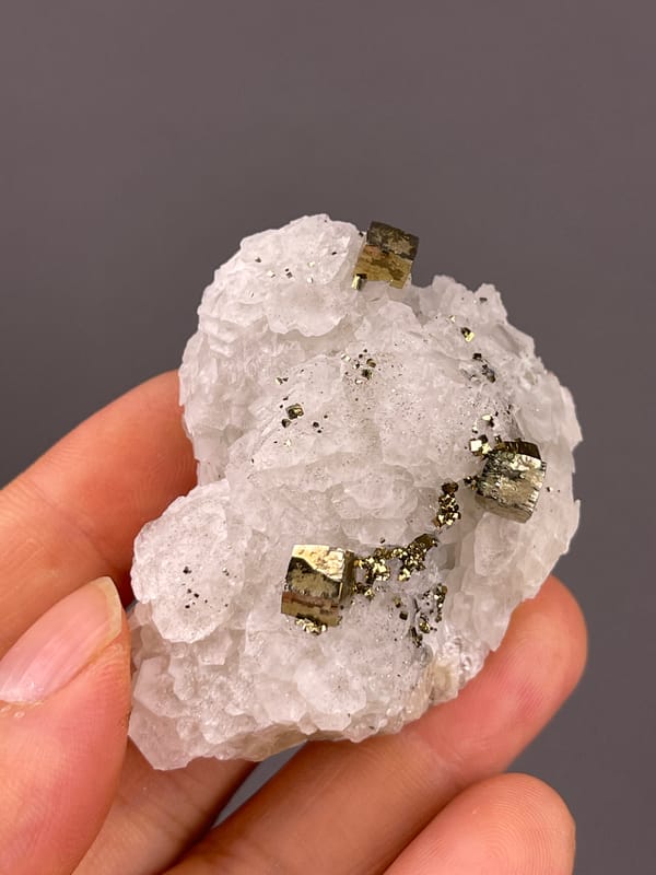 Petal-form Calcite specimen from Longyan, Fujian, China displaying white matrix with sharp pyrite cubes