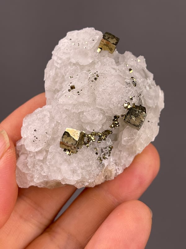 White matrix with sharp pyrite cubes on natural petal-form calcite specimen from Longyan, Fujian, China