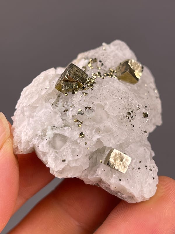 Petal-form Calcite specimen from Longyan, Fujian, China highlighting white matrix with sharp pyrite cubes