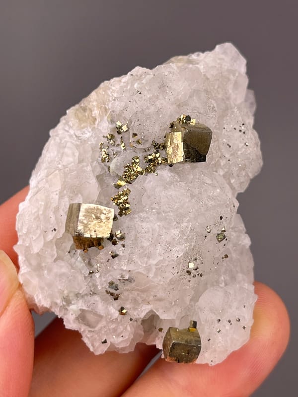 Petal-form Calcite specimen from Longyan, Fujian, China, characterized by white matrix with sharp pyrite cubes