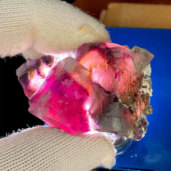 Phantom fluorite glowing magenta when, from Inner Mongolia, China, front view in daylight, view 3 of 9