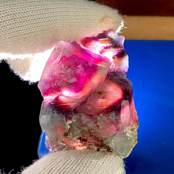 Phantom fluorite glowing magenta when, from Inner Mongolia, China, front view in daylight, view 4 of 9