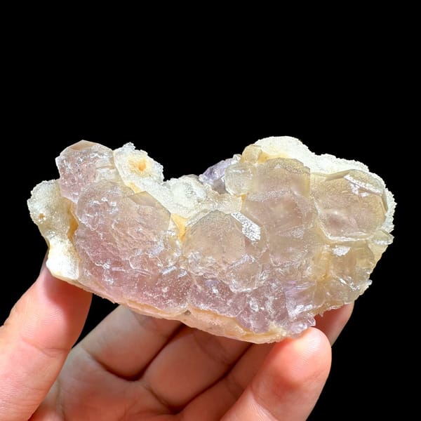 Pink-purple fluorite with quartz, from Jiangxi, China, front view in daylight