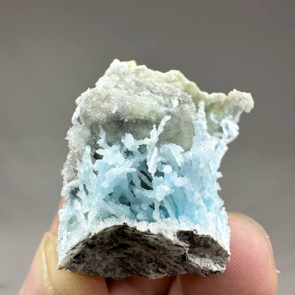 Pocket of sky-blue aragonite needles inside white druse from Yunnan, China