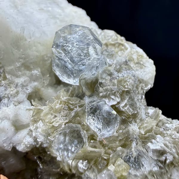Short pale aquamarine prism on muscovite and feldspar from Xuebaoding, Sichuan, China, view 2 of 6
