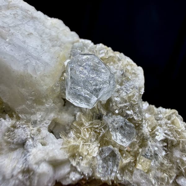 Short pale aquamarine prism on muscovite and feldspar from Xuebaoding, Sichuan, China, view 3 of 6
