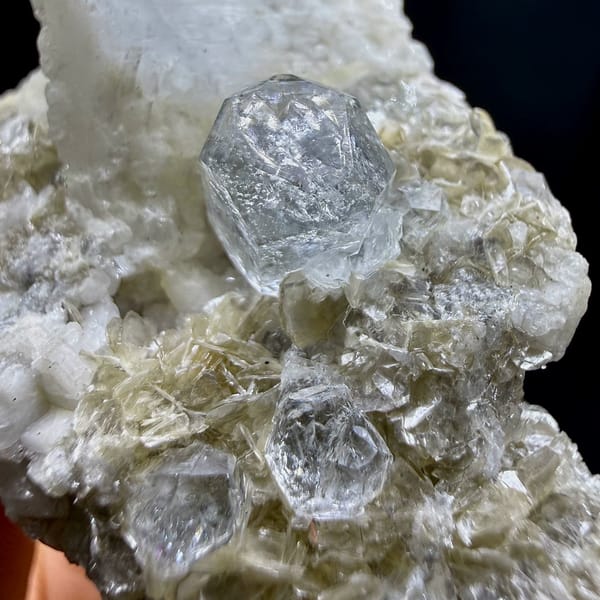 Short pale aquamarine prism on muscovite and feldspar from Xuebaoding, Sichuan, China, view 4 of 6