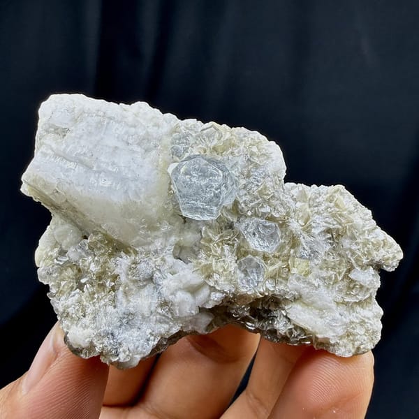 Short pale aquamarine prism on muscovite and feldspar from Xuebaoding, Sichuan, China, view 6 of 6