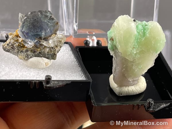 Bulk003 actual mixed mineral specimen box with about 35 different mini natural specimens, including likely fluorite, garnet, stibnite, quartz, aquamarine, tourmaline and grape agate.