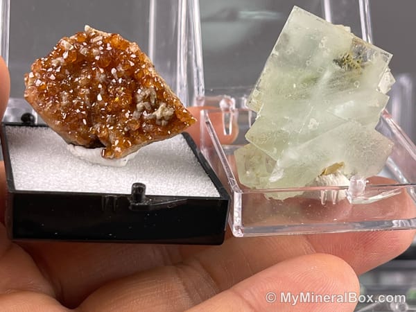 Bulk003 actual mixed mineral specimen box with about 35 different mini natural specimens, including likely fluorite, garnet, stibnite, quartz, aquamarine, tourmaline and grape agate.