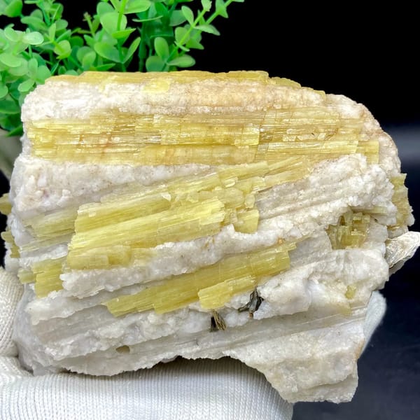 Block of golden topaz columns in white matrix from Germany, close-up of the crystal faces