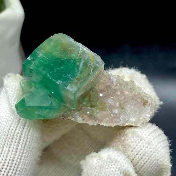 Glassy green fluorite cube on druzy quartz from Hebei — detail view