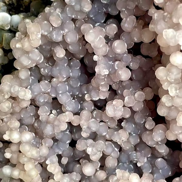 Tall tower of pearly lavender grape agate on stand from Indonesia, second angle