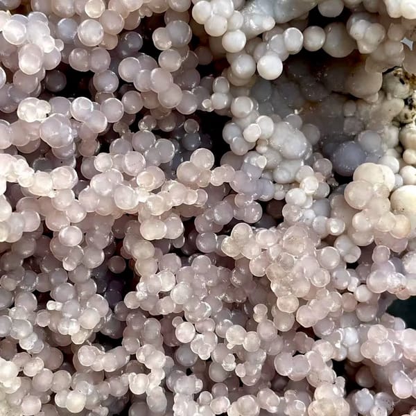 Tall tower of pearly lavender grape agate on stand from Indonesia, reverse side