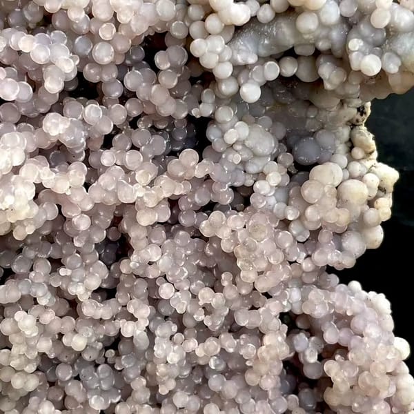 Tall tower of pearly lavender grape agate on stand from Indonesia, top view