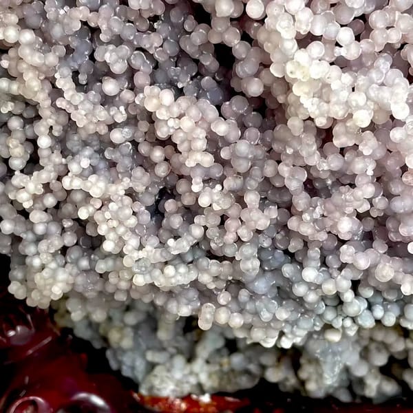 Tall tower of pearly lavender grape agate on stand from Indonesia, side view