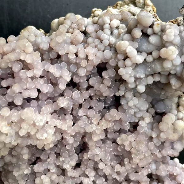 Tall tower of pearly lavender grape agate on stand from Indonesia, close-up of terminations