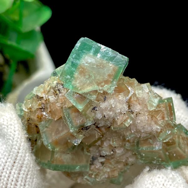 Green cubic fluorite on pale matrix from Hebei — detail view