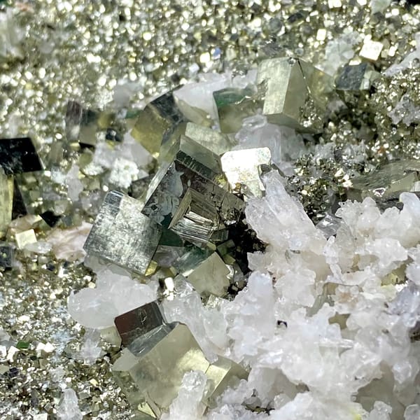 Tall tower of pyrite and white quartz on stand from Shangbao, Hunan, China, detail of the matrix contact