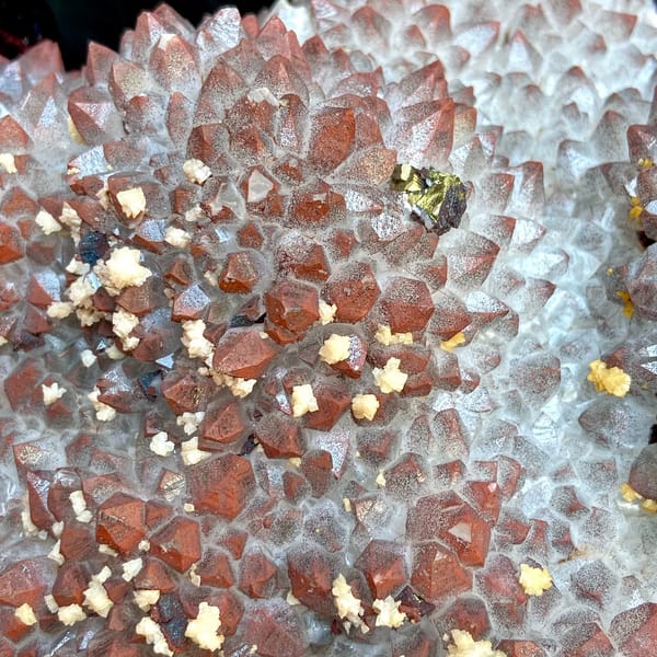 Red-skinned quartz plate with chalcopyrite and dolomite on stand from Jiangxi, China, top view