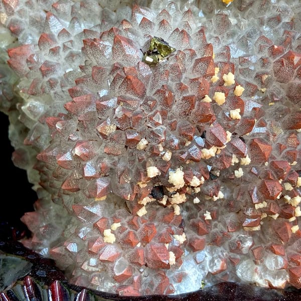 Red-skinned quartz plate with chalcopyrite and dolomite on stand from Jiangxi, China, side view