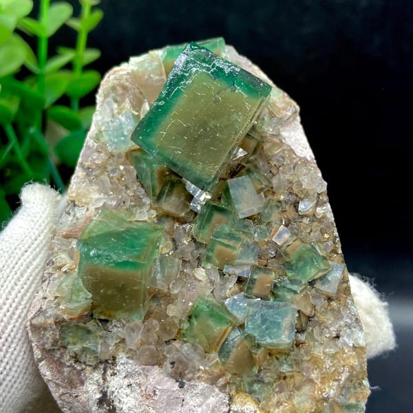 Front detail of the green cube and adjacent smaller fluorite crystals