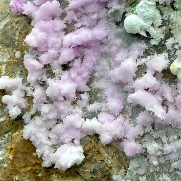 Large plate of pink aragonite crusts on tan rock from Yunnan, China, second angle