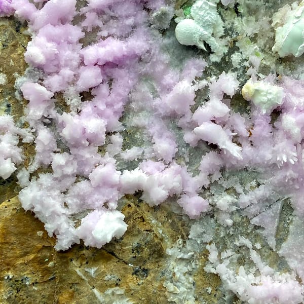 Large plate of pink aragonite crusts on tan rock from Yunnan, China, top view