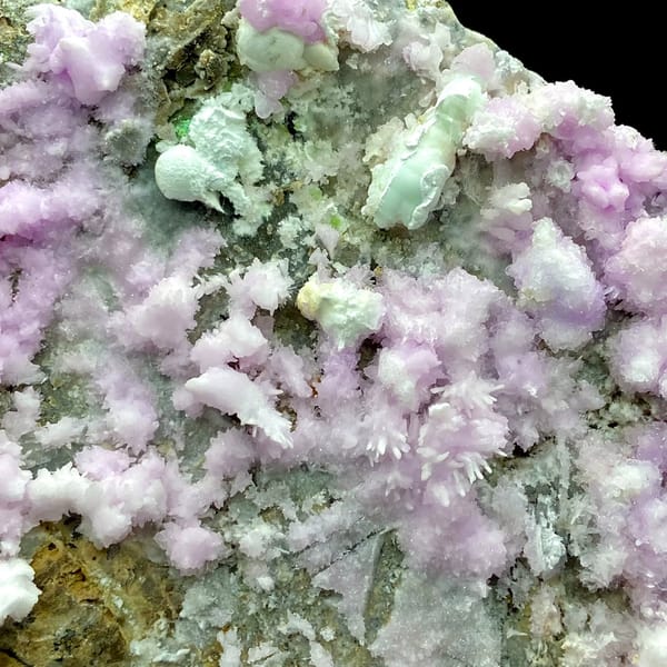 Large plate of pink aragonite crusts on tan rock from Yunnan, China, overall view