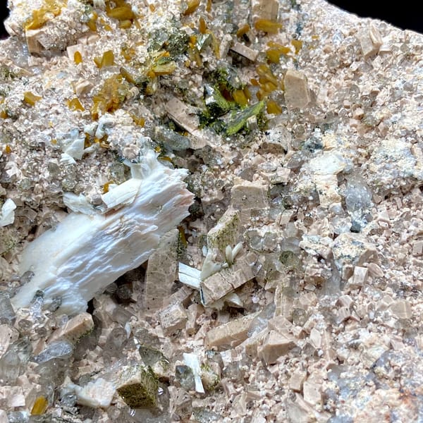Multi-mineral plate of feldspar, zeolite, quartz, pyrite and epidote on stand from Fujian, China, side view