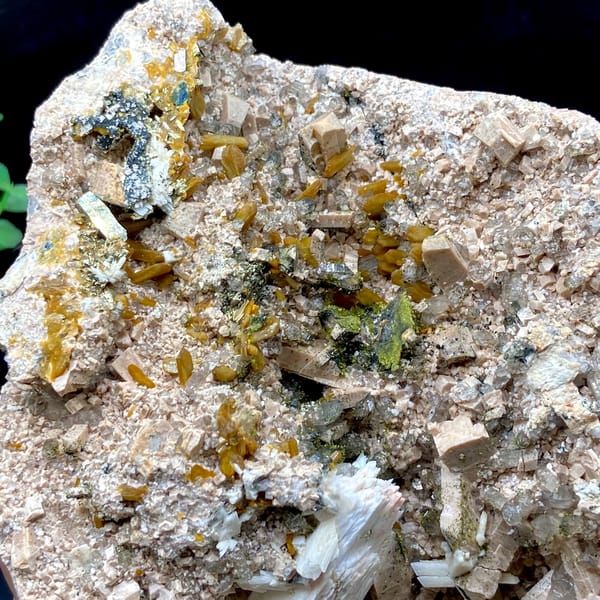 Multi-mineral plate of feldspar, zeolite, quartz, pyrite and epidote on stand from Fujian, China, close-up of terminations