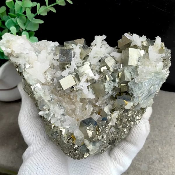 Large cluster of pyrite cubes and white quartz from Hunan, China, held in gloved hand
