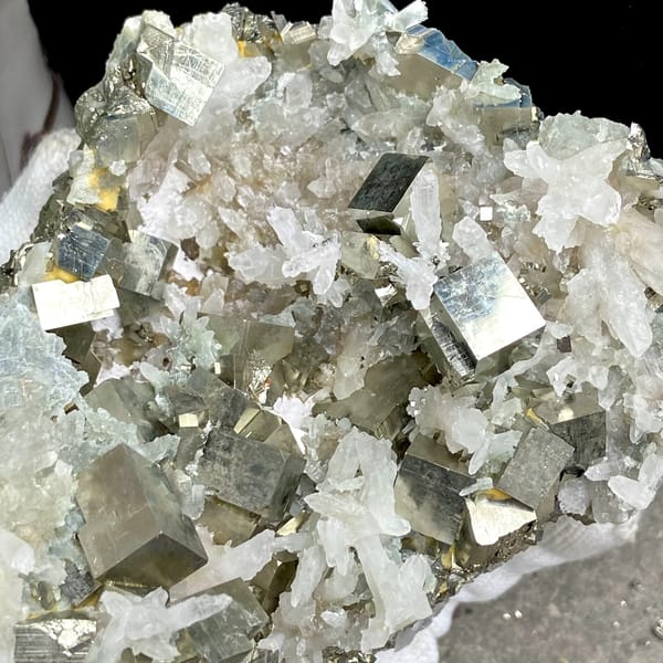 Large cluster of pyrite cubes and white quartz from Hunan, China, side view