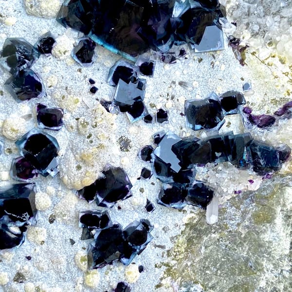 Plate of purple-cored window fluorite on stand from Inner Mongolia, China, side view