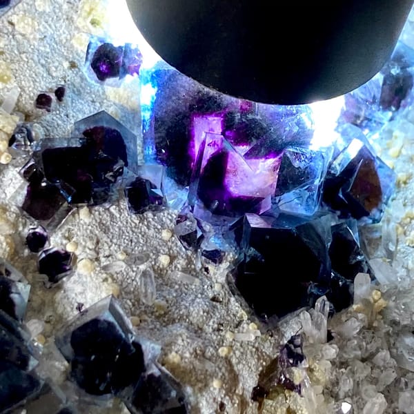 Plate of purple-cored window fluorite on stand from Inner Mongolia, China, close-up of terminations