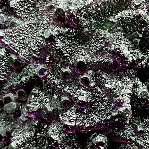Large two-tone fluorite octahedra display piece on stand from Zhejiang, China, detail of the matrix contact
