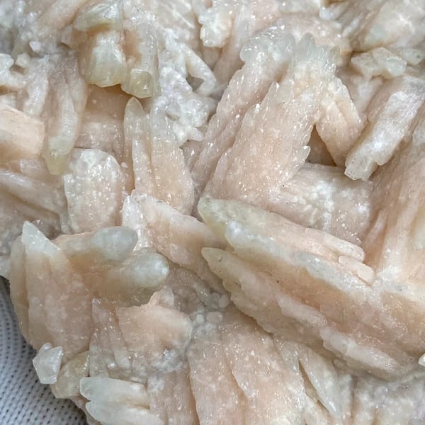 Large plate of pale pink feather calcite blades from Guizhou, China, close-up of terminations