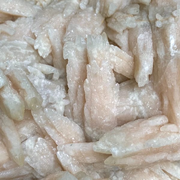 Large plate of pale pink feather calcite blades from Guizhou, China, overall view