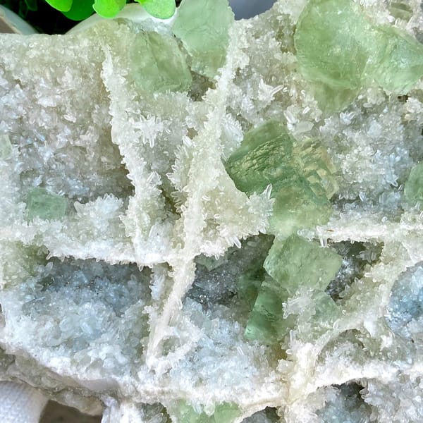 Large plate of pale green stepped fluorite over quartz from Fujian, China, side view