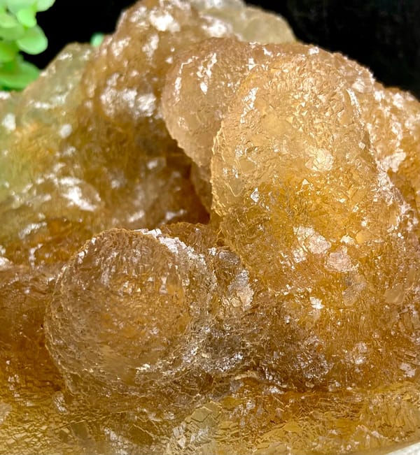 Amber pineapple fluorite of stacked translucent columns from Henan, China, close-up of the crystal faces