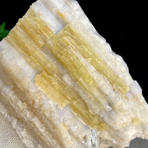 Bundle of golden-yellow prismatic topaz columns from Germany, side view