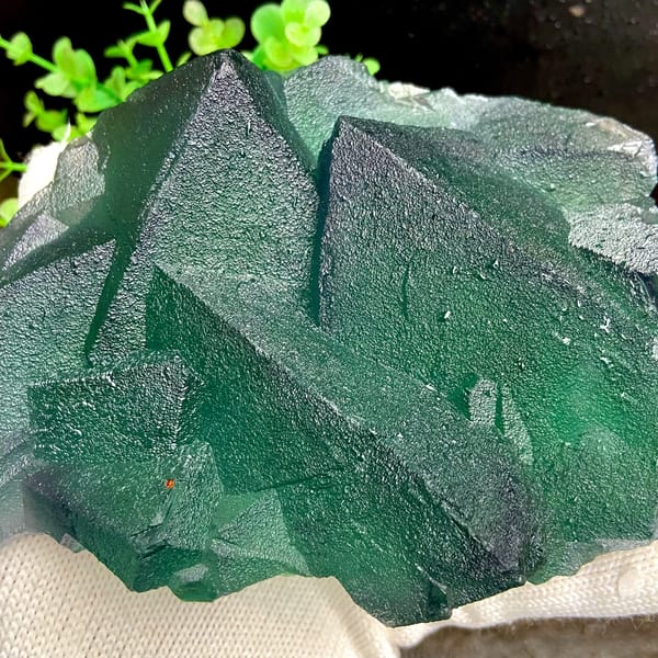Block of large green fluorite octahedra from Zhejiang, China, close-up of the crystal faces