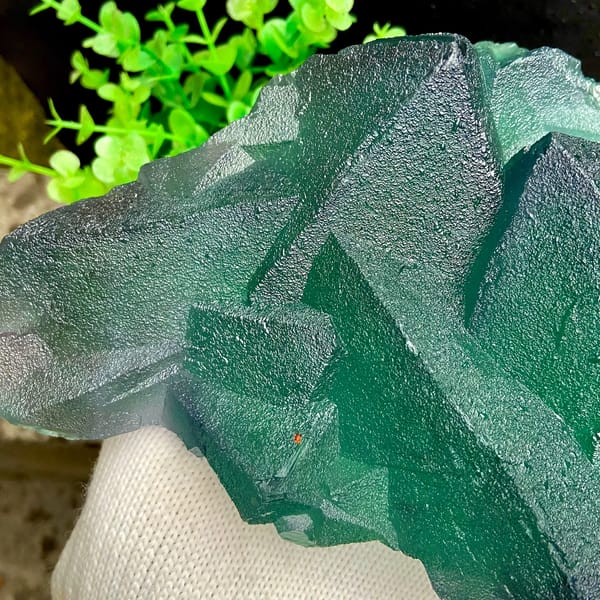 Block of large green fluorite octahedra from Zhejiang, China, detail of the matrix contact