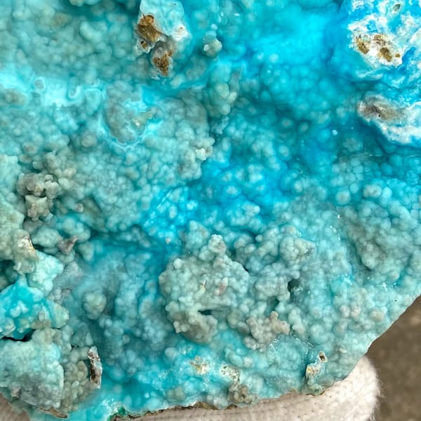 Large plate of turquoise-blue botryoidal hemimorphite from Yunnan, China, detail of the matrix contact