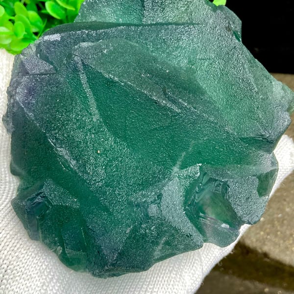 Cluster of green fluorite octahedra with purple edges from Zhejiang, China, detail of the matrix contact