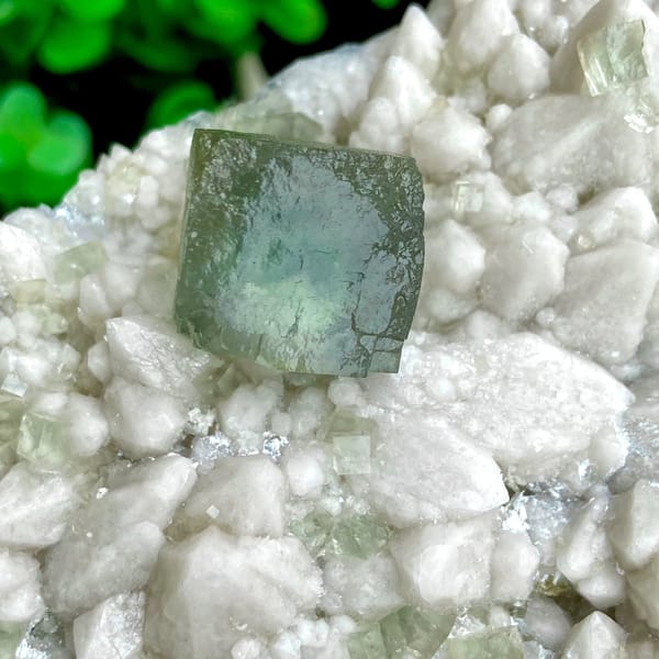 White quartz plate with pale green fluorite cubes from Inner Mongolia, China, close-up of the crystal faces