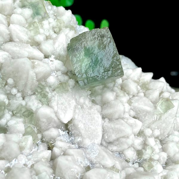 White quartz plate with pale green fluorite cubes from Inner Mongolia, China, detail of the matrix contact